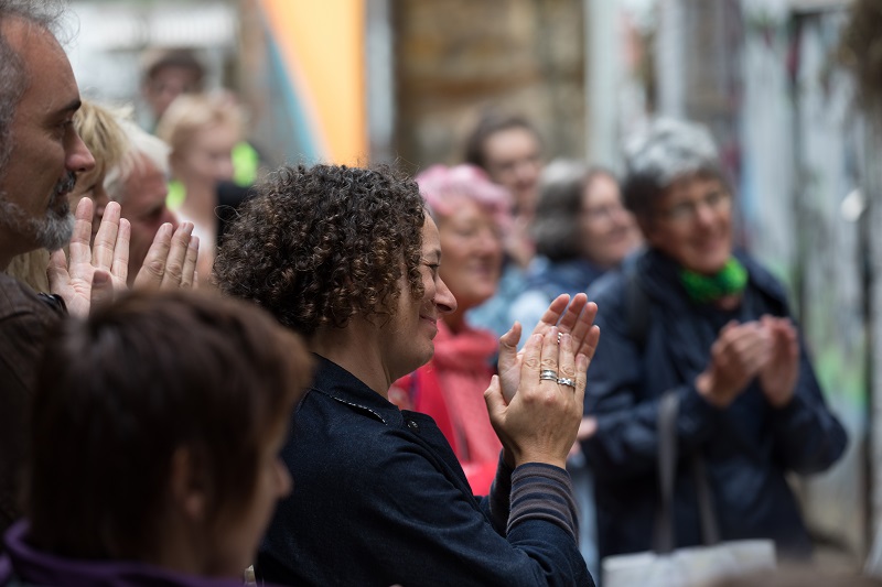 people clapping at a performer 