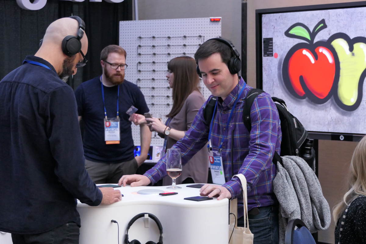 A man experiments with a sound listening station at the MW18 conference. 